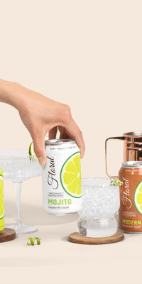 A stylish can of Delta-9 THC-infused cocktail garnished with citrus and herbs, set against a vibrant bar background.