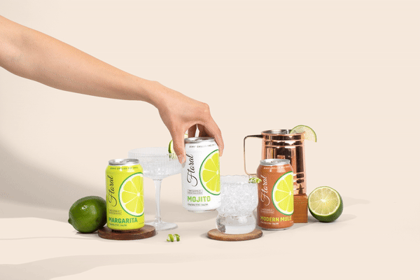 A stylish can of Delta-9 THC-infused cocktail garnished with citrus and herbs, set against a vibrant bar background.