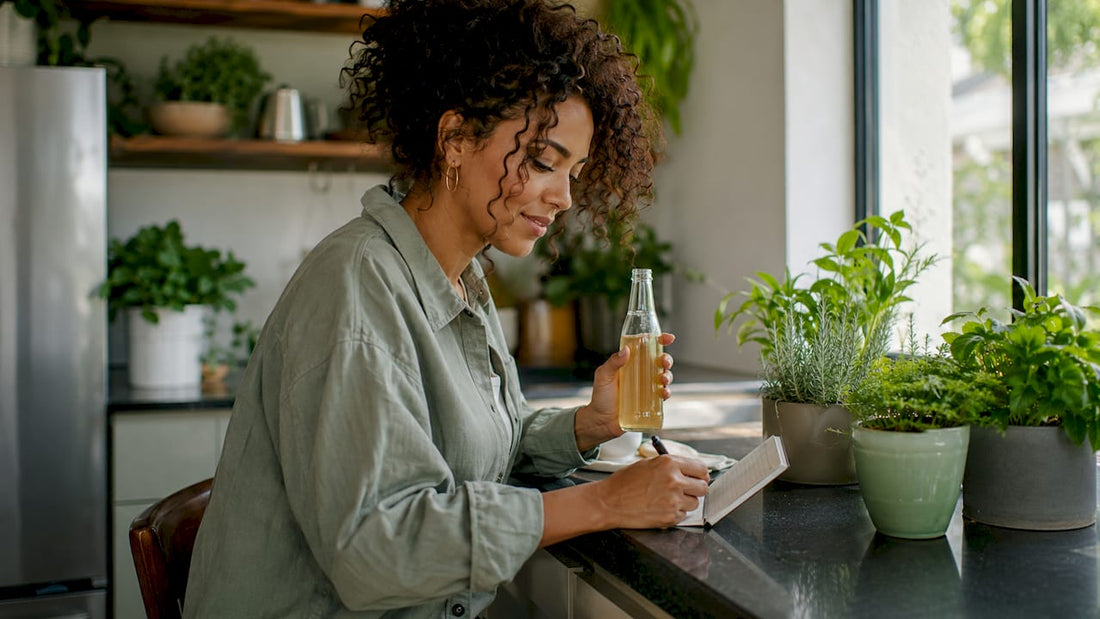 Woman sitting on couch with THC drink and notes