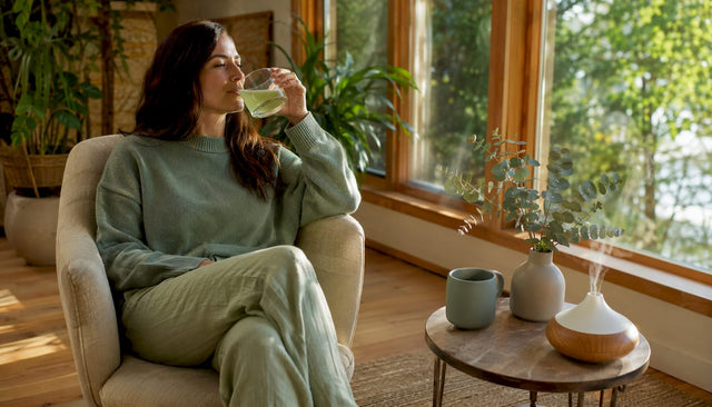 Woman relaxing with THC beverage in living room