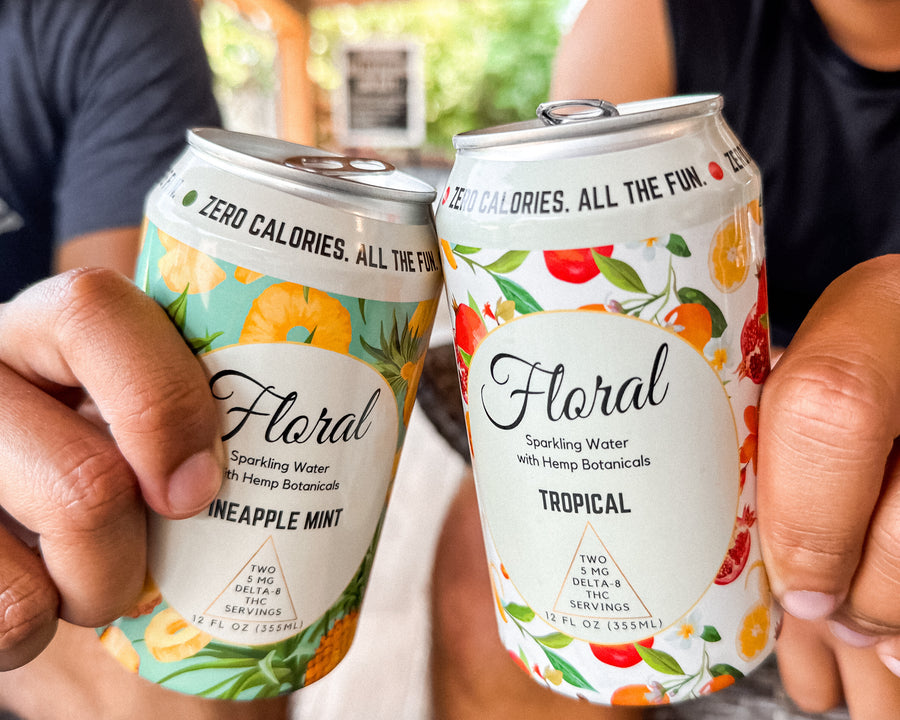 Two men holding cans of Floral Beverages' THC-infused seltzers. 