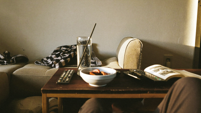 Living room coffee table with a bowl, open book, and glass of water