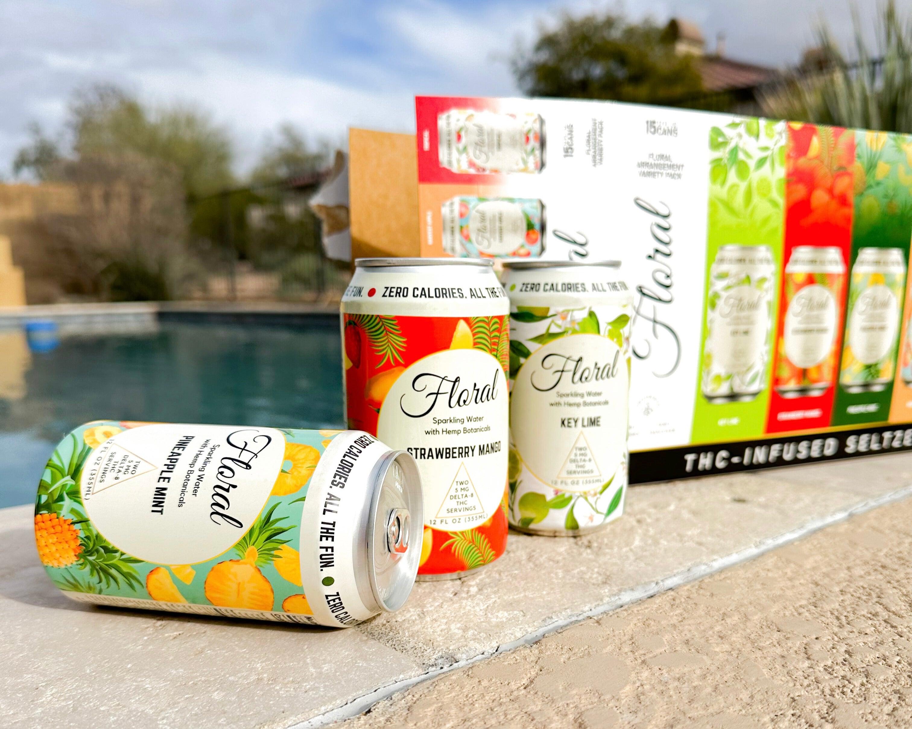 Cans of Floral Beverages THC seltzers sitting outside between an open box