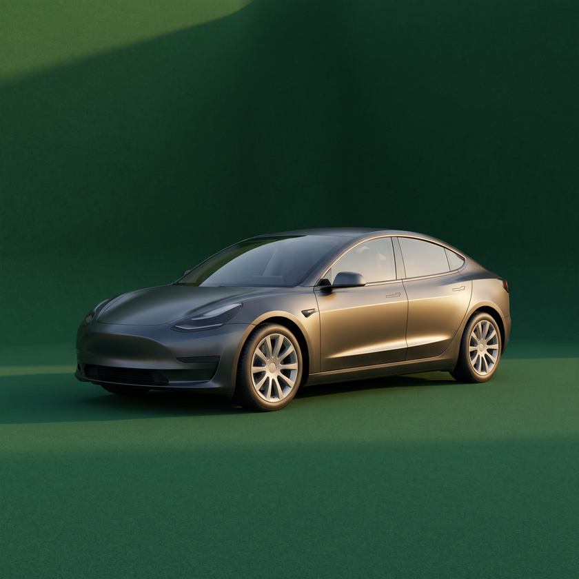 Gray Tesla Model 3 sedan on a green background