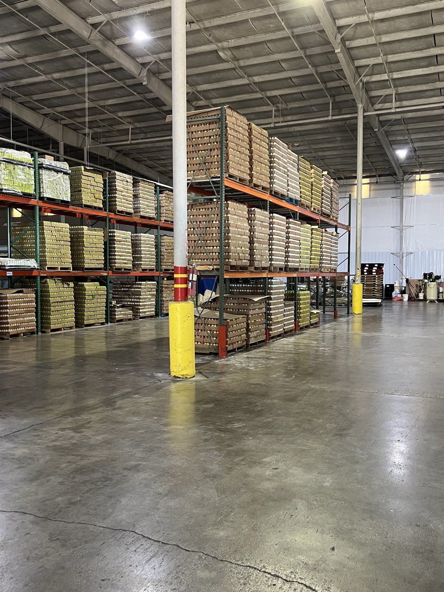 Tall racks of palletized cases in the warehouse