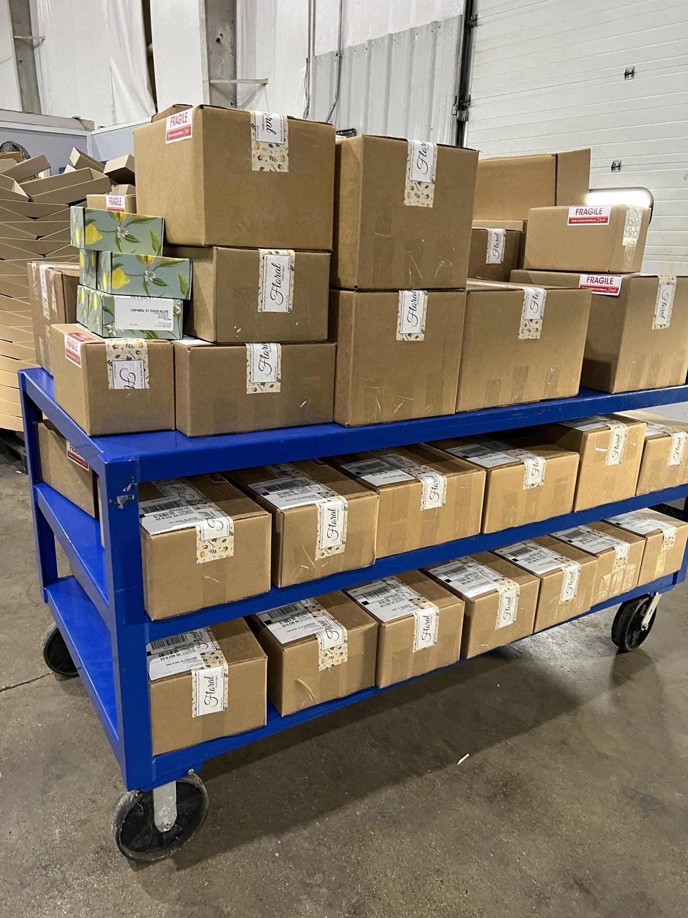 Cart stacked with boxed Floral orders ready to ship
