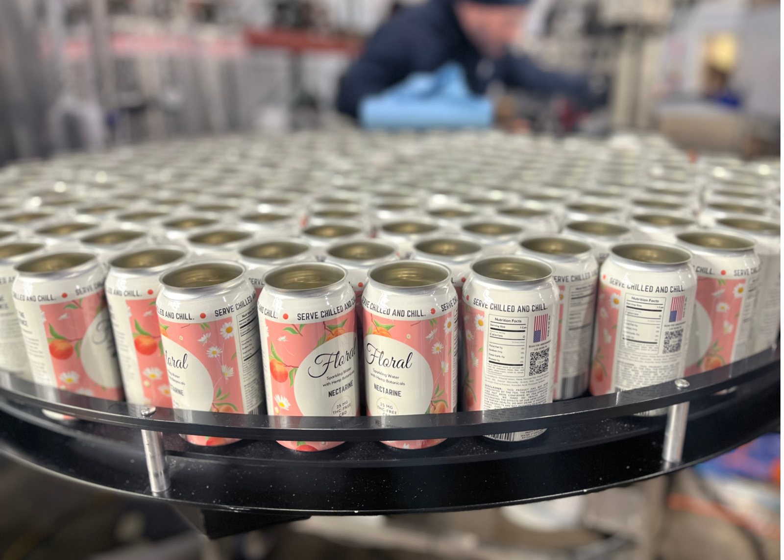 Filled Floral cans on the canning line