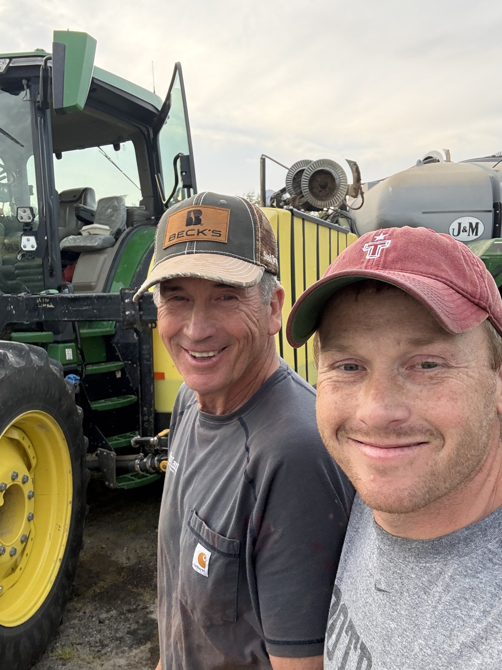 Two Floral farmers beside a tractor