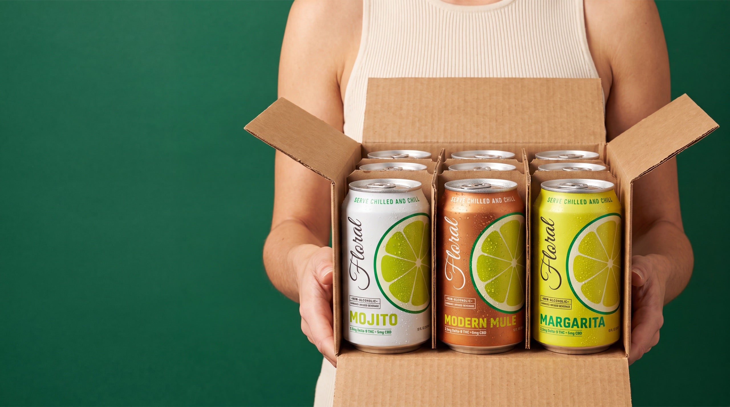 Person opening a box of Floral THC beverage cans